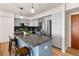 Modern kitchen with granite countertops, stainless steel appliances, and light blue cabinetry at 601 W 11Th Ave # 910, Denver, CO 80204