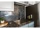 Modern kitchen sink and faucet with stylish backsplash and stainless steel appliances at 601 W 11Th Ave # 910, Denver, CO 80204