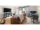 Comfortable living room with hardwood floors, a balcony, a flatscreen television, and a workspace at 601 W 11Th Ave # 910, Denver, CO 80204