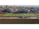 A scenic view from the balcony includes a football field and several buildings in the background at 601 W 11Th Ave # 910, Denver, CO 80204