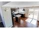 Well-lit kitchen with center island, dark wood cabinets and access to outdoor deck at 10406 Drake Pl, Parker, CO 80134