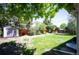 Spacious backyard with a storage shed and mature trees, perfect for outdoor activities at 5523 E Utah Pl, Denver, CO 80222