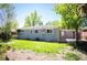 Backyard showcasing the home's exterior, lush lawn, and potential for outdoor enjoyment at 5523 E Utah Pl, Denver, CO 80222
