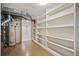 Basement with finished floors and walls and built-in shelving for storage at 5523 E Utah Pl, Denver, CO 80222