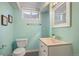 Cozy bathroom featuring a vanity with light countertops and a stylish mirror at 5523 E Utah Pl, Denver, CO 80222