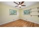 Inviting bedroom featuring hardwood floors, natural light, and a ceiling fan at 5523 E Utah Pl, Denver, CO 80222