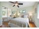 Relaxing bedroom featuring a large closet, neutral tones, and a ceiling fan at 5523 E Utah Pl, Denver, CO 80222