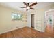 Comfortable bedroom with hardwood floors, built-in shelving, and ample closet space at 5523 E Utah Pl, Denver, CO 80222
