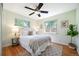 Cozy bedroom featuring plush carpeting, a ceiling fan, and sun-drenched windows at 5523 E Utah Pl, Denver, CO 80222