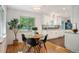 Cozy dining area with bright windows, modern lighting, and a seamless flow into the updated kitchen at 5523 E Utah Pl, Denver, CO 80222