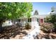 Charming single-story home with mature trees and landscaping leading to a welcoming red front door at 5523 E Utah Pl, Denver, CO 80222