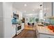 Bright kitchen with modern white cabinetry, stainless steel appliances, and striking blue backsplash at 5523 E Utah Pl, Denver, CO 80222