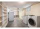 Functional laundry room with shelving, washer, dryer, and utility sink at 5523 E Utah Pl, Denver, CO 80222