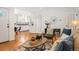 Open-concept living area with views into the modern kitchen, hardwood floors, and stylish interior design elements at 5523 E Utah Pl, Denver, CO 80222