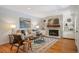 Cozy living room featuring a stone fireplace, built-in shelves, and stylish decor with a patterned rug at 5523 E Utah Pl, Denver, CO 80222