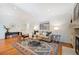 Inviting living room with stone fireplace, hardwood floors, and comfortable seating arrangement near the hearth at 5523 E Utah Pl, Denver, CO 80222