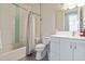Inviting bathroom featuring classic subway tile, a bathtub with a shower, and a vanity with storage at 3227 Quivas St # 1, Denver, CO 80211