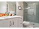 Modern bathroom with glass-enclosed shower, playful accents, and white vanity at 3227 Quivas St # 1, Denver, CO 80211