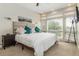 Well-lit bedroom featuring neutral decor, a cozy bed, and large windows offering plenty of natural light at 3227 Quivas St # 1, Denver, CO 80211