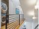 Hallway with in-unit stackable washer and dryer and modern railing at 3227 Quivas St # 1, Denver, CO 80211