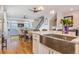 Open kitchen area with stainless steel sink and view of living area with hardwood floors at 3227 Quivas St # 1, Denver, CO 80211