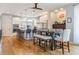 Stylish kitchen and dining area with modern lighting, island seating, and stainless steel appliances at 3227 Quivas St # 1, Denver, CO 80211