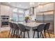 Bright, spacious kitchen with white cabinetry, stainless steel appliances, and a large center island at 3227 Quivas St # 1, Denver, CO 80211