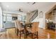 Open concept dining and living area with hardwood floors and modern design elements at 3227 Quivas St # 1, Denver, CO 80211