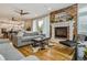 Open-concept living room showcasing fireplace, sleek furniture, and seamless flow to kitchen at 3227 Quivas St # 1, Denver, CO 80211