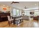 Open concept living room featuring fireplace, hardwood flooring, piano, and dining area at 3227 Quivas St # 1, Denver, CO 80211