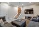 Finished basement with plush seating, mounted television, staircase, and neutral color scheme at 3227 Quivas St # 1, Denver, CO 80211