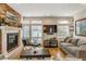 Comfortable living room featuring a fireplace, large windows, and stylish furniture at 3227 Quivas St # 1, Denver, CO 80211