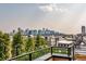 Rooftop patio boasting gorgeous cityscape views, lush trees, and wrought iron railing at 3227 Quivas St # 1, Denver, CO 80211