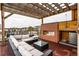 Stylish roof deck with a cozy fireplace and a comfortable seating area for relaxation at 3227 Quivas St # 1, Denver, CO 80211