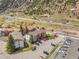 Wide-angle aerial view of condos nestled against the mountains, close to the main road and a large parking lot at 1890 Argentine St # D203, Georgetown, CO 80444