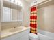 Clean bathroom with a vanity, mirror, and a shower-tub combination with a curtain at 1890 Argentine St # D203, Georgetown, CO 80444