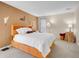 Spacious bedroom with unique decor, featuring a striking orange bed frame and ample natural light at 1890 Argentine St # D203, Georgetown, CO 80444