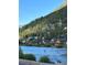 Beautiful community view with paddle boarders on the river and homes nestled against a green hillside at 1890 Argentine St # D203, Georgetown, CO 80444