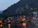 Night view of community with mountain backdrop and lights reflecting off the river at 1890 Argentine St # D203, Georgetown, CO 80444