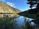 Scenic view of lake surrounded by mountains and trees, reflecting the sky at 1890 Argentine St # D203, Georgetown, CO 80444