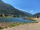 Beautiful lakefront view featuring crystal-clear water and mountains and homes in the background at 1890 Argentine St # D203, Georgetown, CO 80444