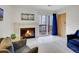 Inviting living room with a fireplace, sliding door access to a balcony, and cozy seating at 1890 Argentine St # D203, Georgetown, CO 80444