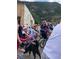 Children in a parade led by a dog walker wearing a red, white, and blue hat at 1890 Argentine St # D203, Georgetown, CO 80444