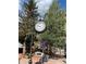 Vintage-style street clock with floral baskets in Georgetown, Colorado, creating a quaint, inviting atmosphere at 1890 Argentine St # D203, Georgetown, CO 80444