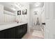 Bathroom featuring a sleek vanity with countertop, modern fixtures, and updated shower and tub combo at 5318 Truckee St, Denver, CO 80249