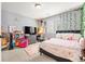 This stylish bedroom features a gray accent wall, cozy bed, and a functional desk area at 5318 Truckee St, Denver, CO 80249