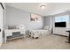 Bright bedroom featuring light gray walls, a large window, and a cozy, paneled bed at 5318 Truckee St, Denver, CO 80249