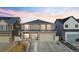 Charming two-story home with a two-car garage and welcoming front porch under a colorful sky at 5318 Truckee St, Denver, CO 80249