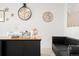 Well-lit home office with a large desk and a comfortable black leather sofa at 5318 Truckee St, Denver, CO 80249