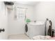Functional laundry room with a window and modern washer and dryer for easy laundry days at 5318 Truckee St, Denver, CO 80249